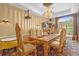 Formal dining room with ornate gold chairs and chandelier at 7440 Aloma Ave, Winter Park, FL 32792