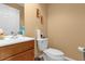 Clean and simple bathroom with wood cabinets and white toilet at 7440 Aloma Ave, Winter Park, FL 32792
