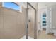 Well-lit shower with glass enclosure and view into bedroom at 7766 Westland Dr, Kissimmee, FL 34747