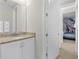 Bathroom with granite countertop and white cabinets at 7766 Westland Dr, Kissimmee, FL 34747