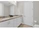 Double vanity bathroom with granite countertop and white cabinets at 7766 Westland Dr, Kissimmee, FL 34747