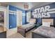 Two twin beds in a Star Wars themed bedroom with an adjoining bathroom at 7766 Westland Dr, Kissimmee, FL 34747