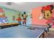 Game room featuring ping pong and pool tables, along with Disney character wall art at 7766 Westland Dr, Kissimmee, FL 34747