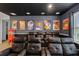Home theater with black recliner seating and movie posters at 7766 Westland Dr, Kissimmee, FL 34747