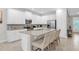 Modern kitchen with white cabinets, granite countertops, and stainless steel appliances at 7766 Westland Dr, Kissimmee, FL 34747