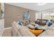 Open concept living room with comfortable seating and large screen TV at 7766 Westland Dr, Kissimmee, FL 34747