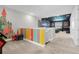 Playroom with colorful wall and access to theater at 7766 Westland Dr, Kissimmee, FL 34747