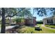 House exterior with orange walls, landscaping, and a driveway at 836 Grand Canal Dr, Kissimmee, FL 34759