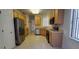 Kitchen with light wood cabinets, stainless steel appliances, and tile floor at 836 Grand Canal Dr, Kissimmee, FL 34759
