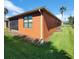 House exterior showcasing an orange wall with screened patio at 836 Grand Canal Dr, Kissimmee, FL 34759