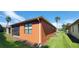 House exterior showcasing an orange wall with screened patio at 836 Grand Canal Dr, Kissimmee, FL 34759