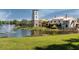 Scenic pond view with fountain and community clubhouse at 836 Grand Canal Dr, Kissimmee, FL 34759