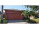 Orange house exterior with a two-car garage and palm trees at 836 Grand Canal Dr, Kissimmee, FL 34759