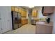 Well-equipped kitchen featuring stainless steel appliances and light wood cabinets at 836 Grand Canal Dr, Kissimmee, FL 34759