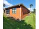 House exterior showcasing an orange wall with screened patio at 836 Grand Canal Dr, Kissimmee, FL 34759