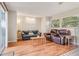 Living room with wood-look floors, comfy seating and access to patio at 8626 Baylor Cir, Orlando, FL 32817