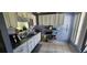 Galley kitchen with granite countertops and white cabinets at 871 Lake Jackson Cir, Apopka, FL 32703