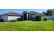 House exterior with solar panels and lawn at 871 Lake Jackson Cir, Apopka, FL 32703