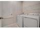 Laundry room with washer, dryer, and overhead shelving at 871 Pebble Crest Ln, Eagle Lake, FL 33839