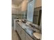 Double vanity bathroom with granite countertop and large shower at 8918 Tropical Haven Ct, Kissimmee, FL 34747