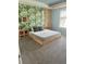 Guest bedroom with a full-size bed and tropical-themed wallpaper at 8918 Tropical Haven Ct, Kissimmee, FL 34747