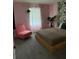 Bedroom with a wooden platform bed, pink walls and tropical-themed wallpaper at 8918 Tropical Haven Ct, Kissimmee, FL 34747