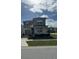 Two-story house with light brown siding, shutters, and a paved driveway at 8918 Tropical Haven Ct, Kissimmee, FL 34747