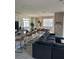Open floor plan kitchen with island, seating, and dark gray sectional sofa at 8918 Tropical Haven Ct, Kissimmee, FL 34747