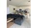 Open concept kitchen with island and dark gray sectional sofa at 8918 Tropical Haven Ct, Kissimmee, FL 34747