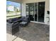 Covered patio with wicker furniture and glass sliding doors at 8918 Tropical Haven Ct, Kissimmee, FL 34747