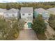 Aerial view of houses with gray roofs and a shared pool at 1460 Reunion Blvd, Reunion, FL 34747