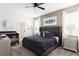 Main bedroom with a gray upholstered bed, and plenty of natural light at 1540 Maidstone Ct, Davenport, FL 33896