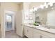Double vanity bathroom with a large mirror and plenty of counter space at 1540 Maidstone Ct, Davenport, FL 33896