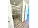 Walk-in shower with tile surround and glass enclosure at 16779 Broadwater Ave, Winter Garden, FL 34787