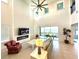 Spacious living room with high ceilings, fireplace, and stunning water views at 16779 Broadwater Ave, Winter Garden, FL 34787