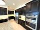 Modern kitchen featuring stainless steel appliances and dark cabinetry at 16779 Broadwater Ave, Winter Garden, FL 34787