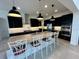 Island kitchen with granite countertops and stainless steel appliances at 16779 Broadwater Ave, Winter Garden, FL 34787