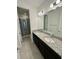Double vanity bathroom with granite countertop at 16779 Broadwater Ave, Winter Garden, FL 34787