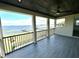 Covered balcony with lake and dock view at 16779 Broadwater Ave, Winter Garden, FL 34787