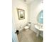 Elegant powder room featuring pedestal sink and wainscoting at 16779 Broadwater Ave, Winter Garden, FL 34787