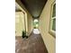 Covered walkway with wood-paneled ceiling and brick flooring at 16779 Broadwater Ave, Winter Garden, FL 34787
