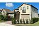 Two-story home with stone accents and a three-car garage at 16779 Broadwater Ave, Winter Garden, FL 34787