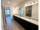 Large bathroom with double vanity and granite countertops at 16779 Broadwater Ave, Winter Garden, FL 34787