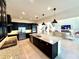 Open concept kitchen with island, stainless steel appliances, and granite countertops at 16779 Broadwater Ave, Winter Garden, FL 34787