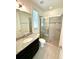 Bathroom with granite vanity and walk-in shower at 16779 Broadwater Ave, Winter Garden, FL 34787