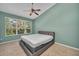 Serene bedroom with a ceiling fan and large window at 2847 Metro Sevilla Dr # 105, Orlando, FL 32835