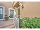 Green front door with white railings and potted plants at 2847 Metro Sevilla Dr # 105, Orlando, FL 32835
