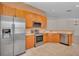 Stainless steel appliances and wood cabinets in kitchen at 2847 Metro Sevilla Dr # 105, Orlando, FL 32835