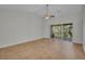 Bright living room with tile floors and access to a screened balcony at 2847 Metro Sevilla Dr # 105, Orlando, FL 32835