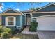 House exterior featuring a walkway to the front door and a white garage door at 2910 Sweetspire Cir, Oviedo, FL 32766